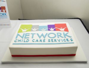 A white cake with the NCCS logo on it