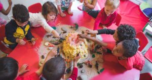 A group of children building a craft volcano